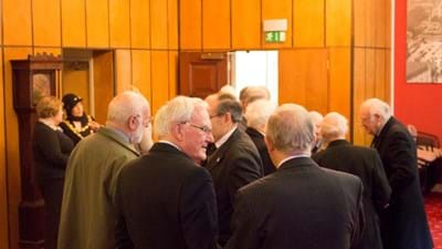The members exchange pleasantries.